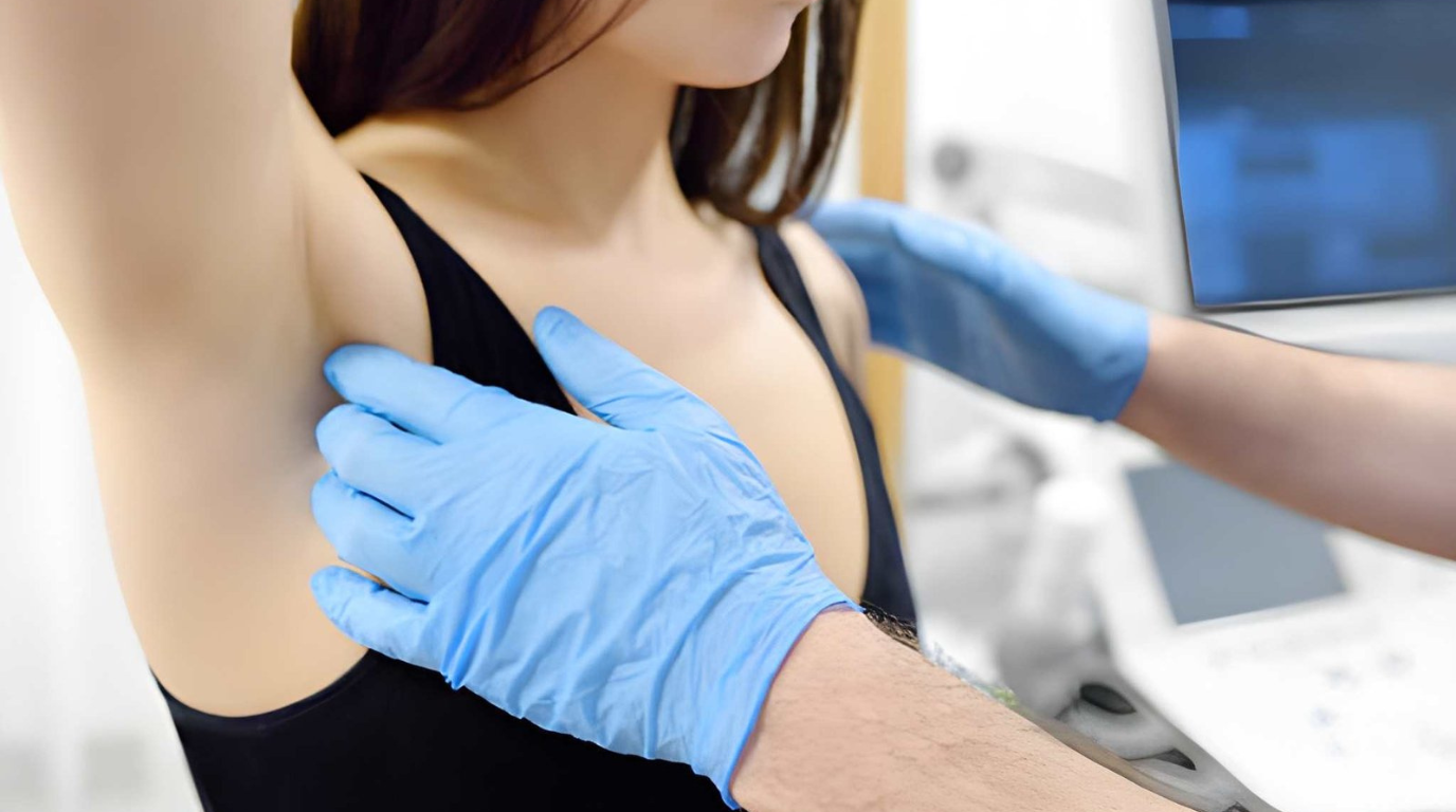 A healthcare professional checks a woman's arm for medical assessment in a doctor's office.