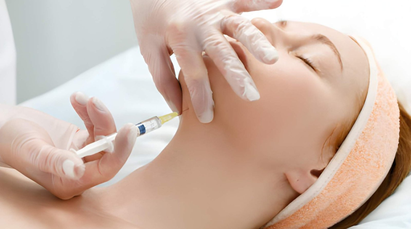 A woman undergoes a facial treatment, surrounded by calming decor and spa equipment.