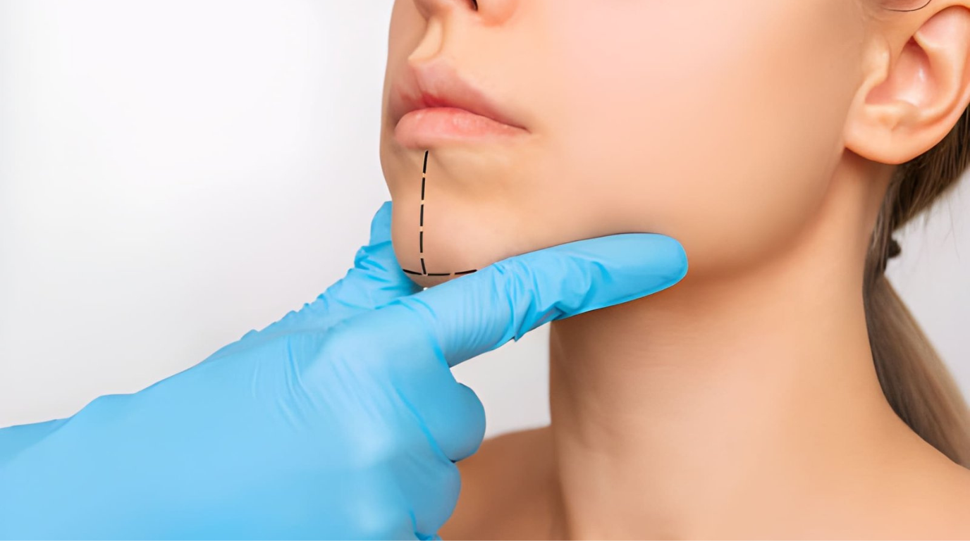 A healthcare professional examines a woman's chin and neck, assessing her health during a routine check-up.